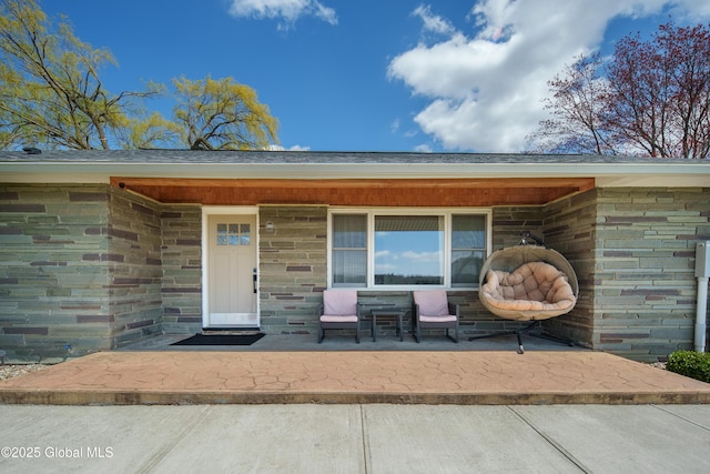view of exterior entry featuring covered porch