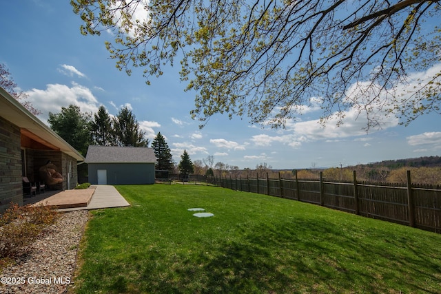 view of yard featuring an outbuilding and a fenced backyard