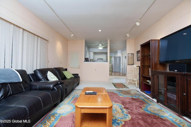 living area featuring ceiling fan and rail lighting