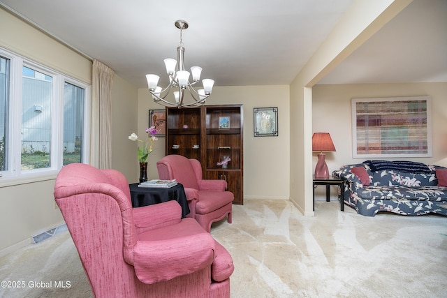 carpeted living room with baseboards, an inviting chandelier, and a wealth of natural light
