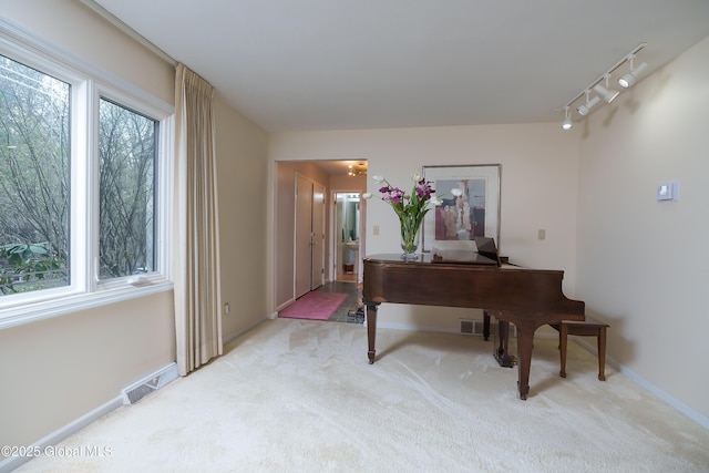 carpeted office with baseboards and visible vents