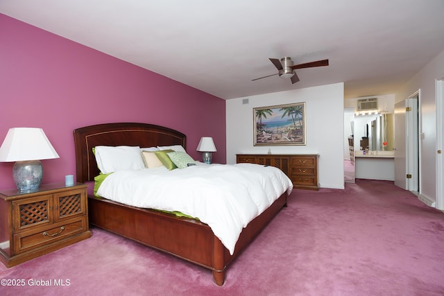 carpeted bedroom with connected bathroom, a ceiling fan, and a wall mounted AC