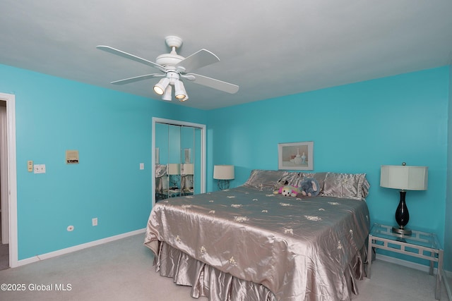 carpeted bedroom featuring baseboards, ceiling fan, and a closet