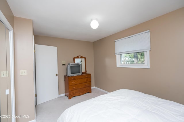 bedroom featuring baseboards and light colored carpet