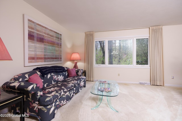 living area with carpet floors, baseboards, and visible vents