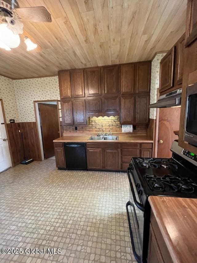 kitchen featuring wood ceiling, a wainscoted wall, stainless steel appliances, and butcher block countertops
