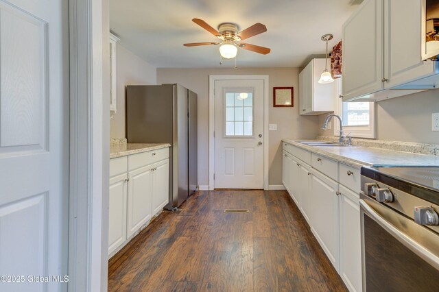 kitchen featuring ceiling fan, dark wood-style floors, a sink, appliances with stainless steel finishes, and white cabinetry