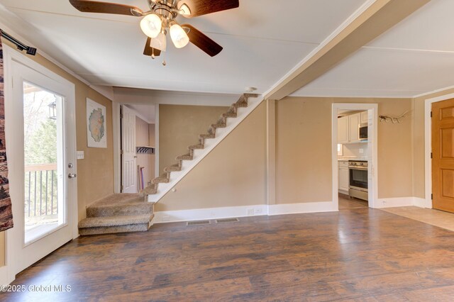 interior space featuring stairway, a healthy amount of sunlight, and wood finished floors