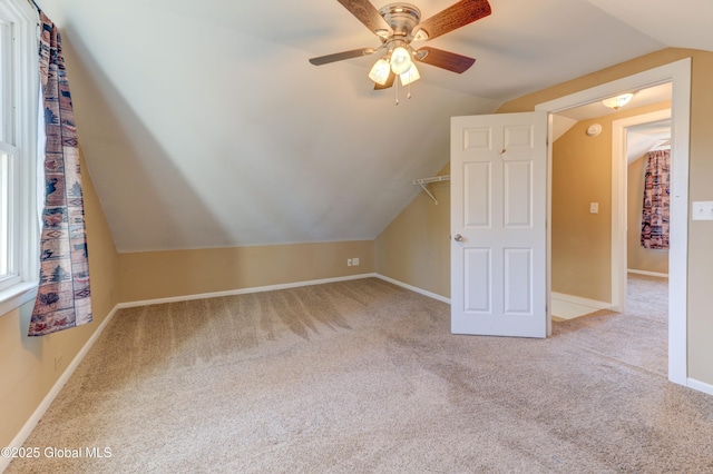 bonus room featuring lofted ceiling, baseboards, carpet, and ceiling fan