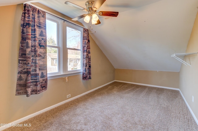 bonus room with vaulted ceiling, carpet flooring, baseboards, and a ceiling fan