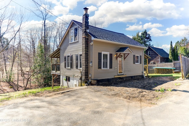 exterior space with a chimney and fence