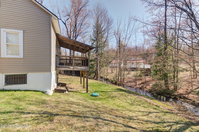 view of yard featuring a wooden deck