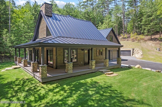 1181 Hunt Lake Rd Unit N, Corinth, NY 12822 - back of house featuring a lawn, aphalt driveway, a porch, metal roof, and a standing seam roof