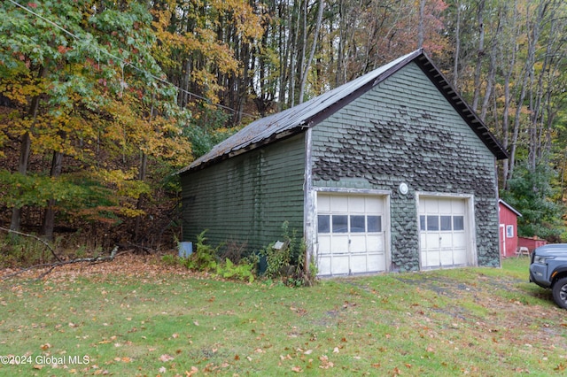 detached garage featuring a wooded view