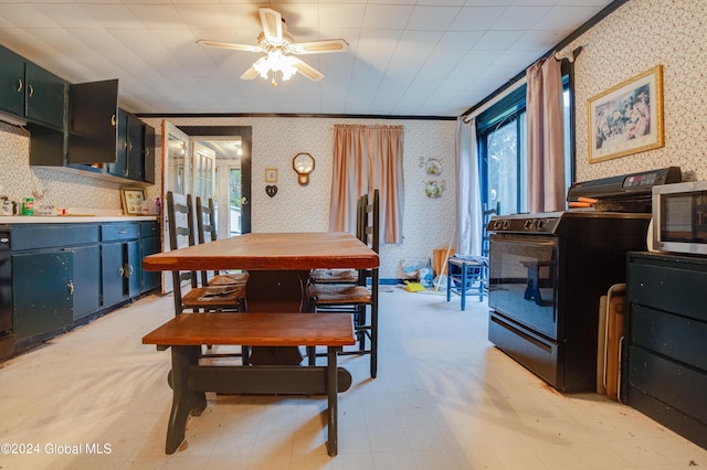 dining room with wallpapered walls, a ceiling fan, and light floors