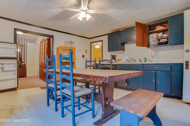 dining room with wallpapered walls, crown molding, a ceiling fan, and light floors