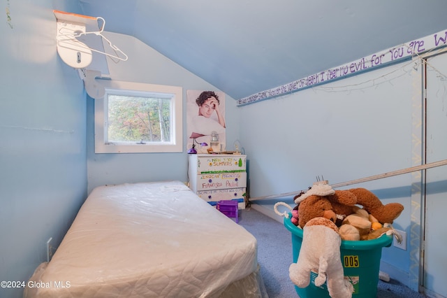 carpeted bedroom featuring lofted ceiling