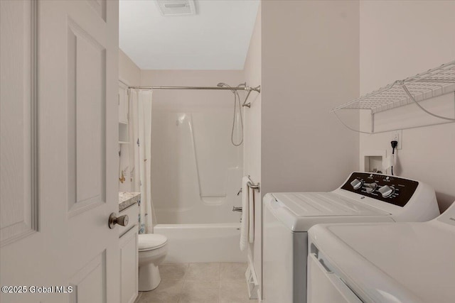 laundry room featuring separate washer and dryer, laundry area, light tile patterned flooring, and visible vents