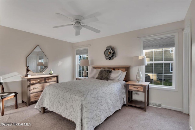 bedroom featuring multiple windows, light colored carpet, and visible vents