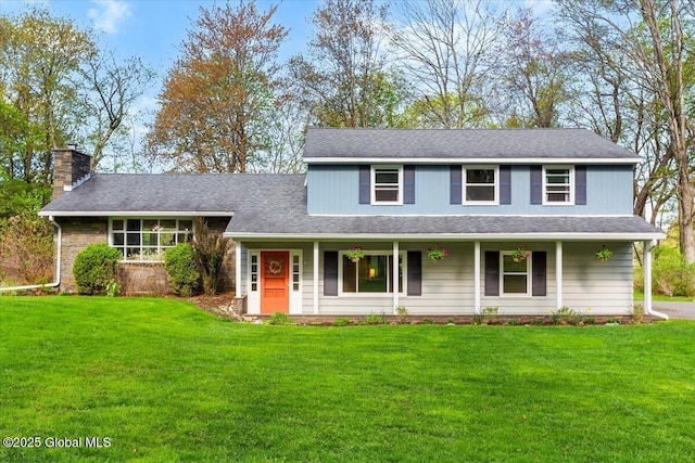 view of front of house with a front yard, covered porch, a chimney, and a shingled roof