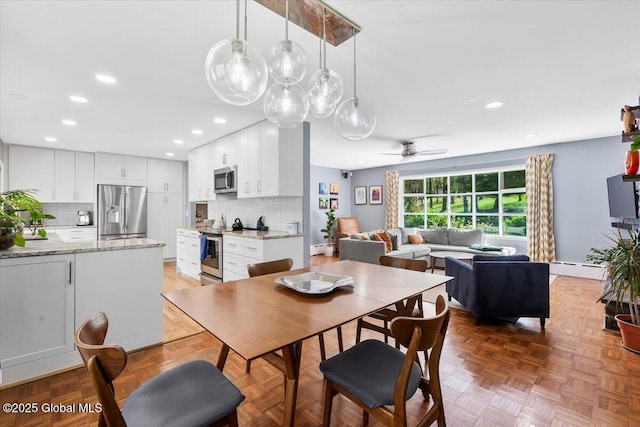 dining room with recessed lighting, a baseboard radiator, and a ceiling fan