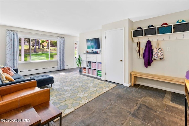 mudroom with a baseboard heating unit, dark stone finish floors, and baseboards