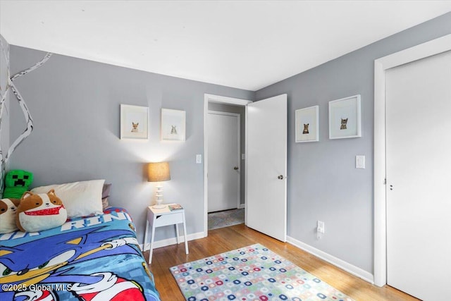 bedroom featuring wood finished floors and baseboards