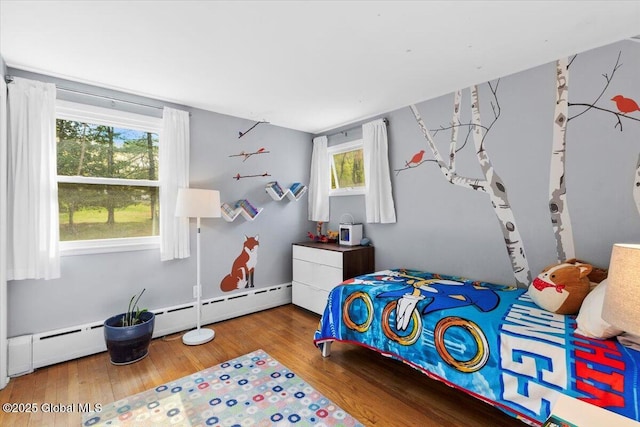 bedroom featuring wood finished floors and multiple windows