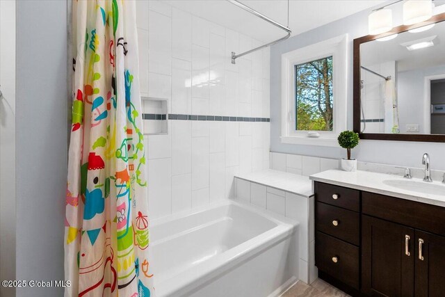 bathroom featuring vanity and shower / bath combo