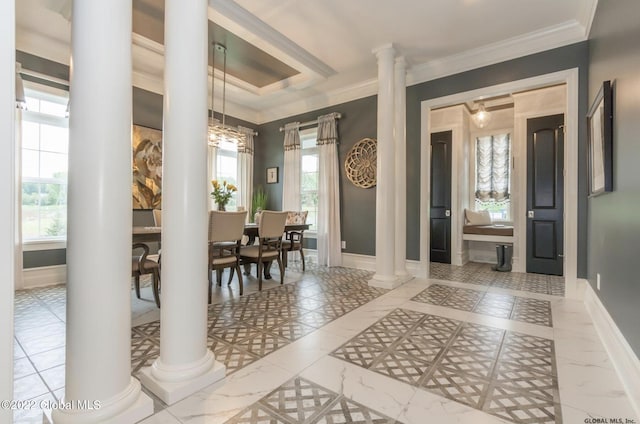 entrance foyer featuring decorative columns, baseboards, and ornamental molding