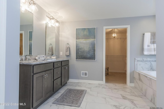 bathroom featuring double vanity, baseboards, visible vents, a spacious closet, and marble finish floor