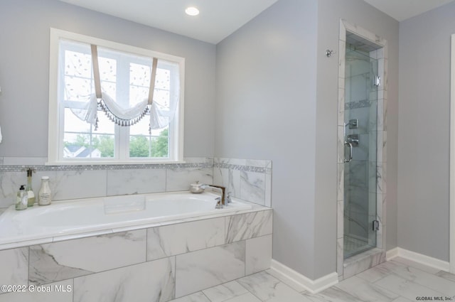 full bath with baseboards, a garden tub, marble finish floor, and a stall shower