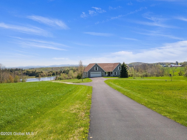 2694 State Route 10, Summit, NY 12175 - view of front of home with driveway, a front yard, a mountain view, and an attached garage