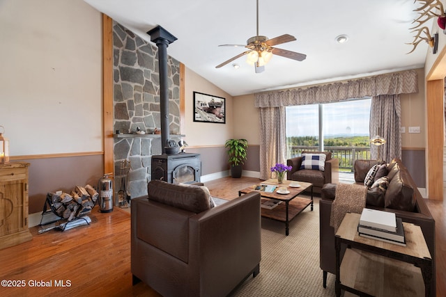2694 State Route 10, Summit, NY 12175 - living area with a ceiling fan, a wood stove, wood finished floors, lofted ceiling, and baseboards