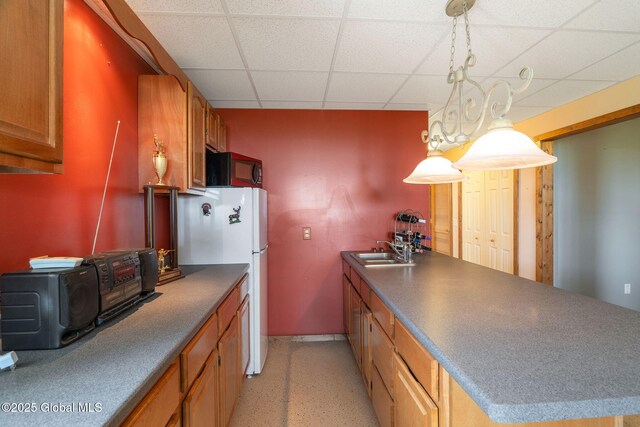 2694 State Route 10, Summit, NY 12175 - kitchen with a drop ceiling, freestanding refrigerator, a sink, black microwave, and baseboards