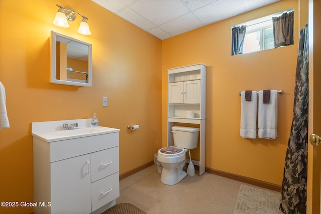 2694 State Route 10, Summit, NY 12175 - bathroom with toilet, vanity, a drop ceiling, and baseboards