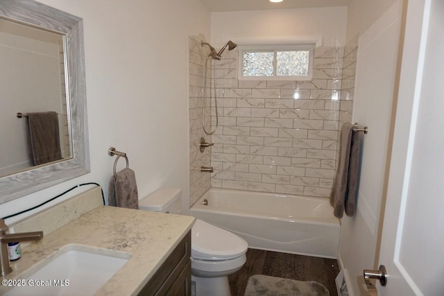full bath with wood finished floors, toilet, vanity, and bathtub / shower combination