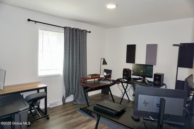 home office with visible vents, baseboards, and wood finished floors
