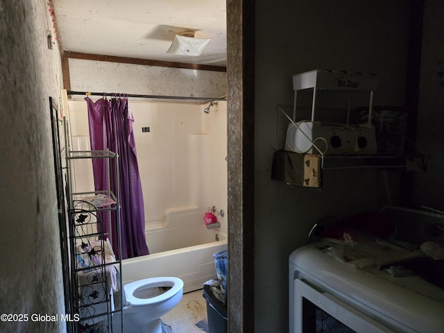 bathroom with shower / tub combo, washer / dryer, and toilet