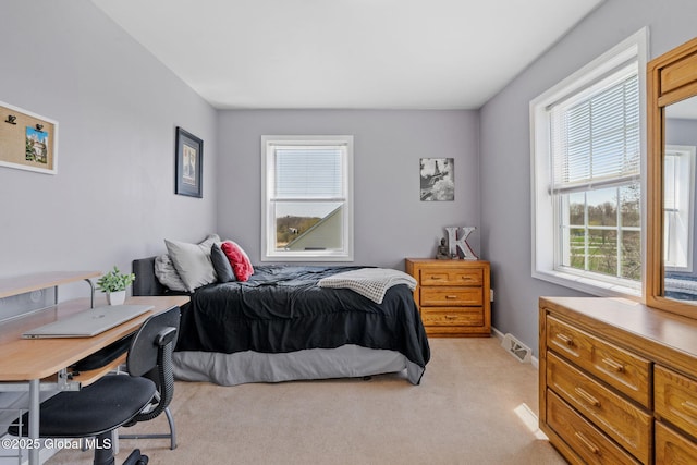 bedroom featuring light carpet and visible vents