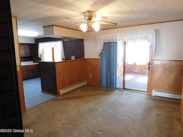 6 Riverview St, South Glens Falls, NY 12803 - empty room with a baseboard heating unit, plenty of natural light, and wooden walls