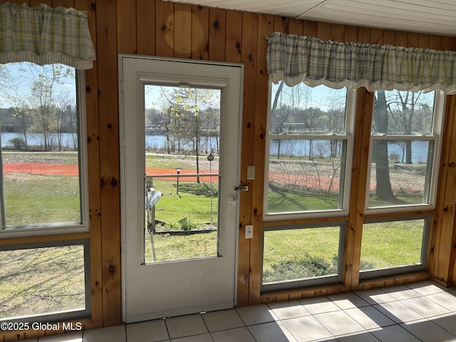 6 Riverview St, South Glens Falls, NY 12803 - doorway to outside with light tile patterned floors, wood walls, and a water view