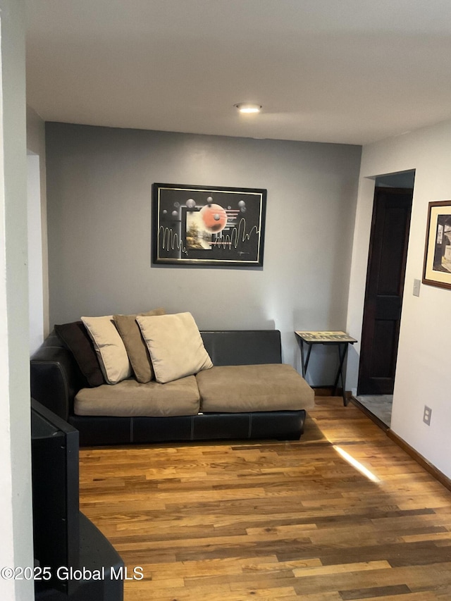 living area with recessed lighting, wood finished floors, and baseboards