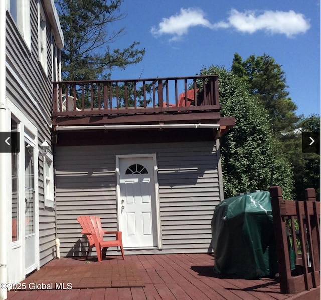wooden deck featuring a grill