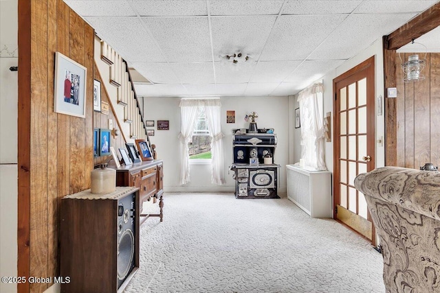 interior space featuring carpet floors and wood walls
