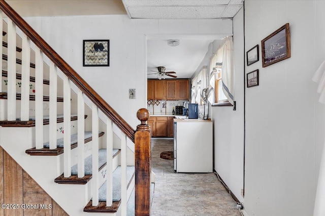 stairs with a ceiling fan