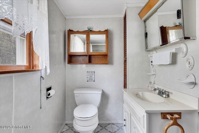 half bathroom with crown molding, toilet, and vanity