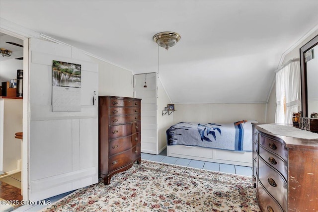 tiled bedroom with lofted ceiling
