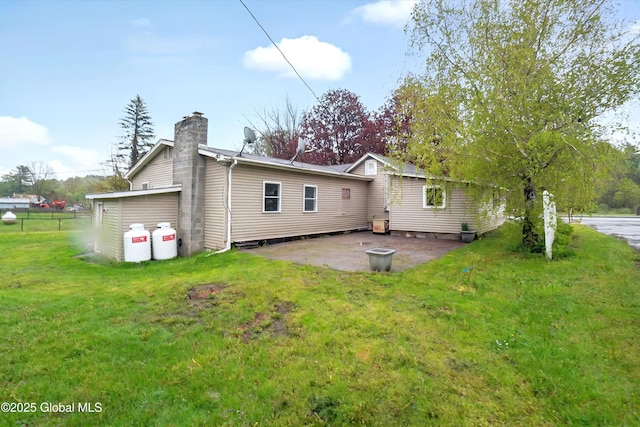 286 State Hwy Unit 80, Fort Plain, NY 13339 - rear view of house featuring a chimney, a patio, and a lawn