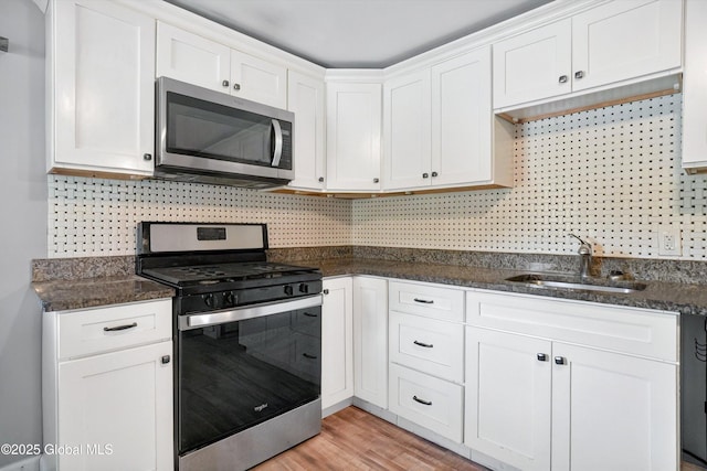 286 State Hwy Unit 80, Fort Plain, NY 13339 - kitchen with stainless steel appliances, a sink, decorative backsplash, and white cabinets